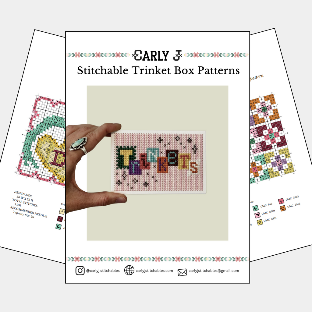 A booklet or pattern cover titled "Carly J Stitchable Trinket Box Patterns" shown on a light gray background, with two additional pattern sheets fanned behind it. The center cover features a small cross-stitch style trinket box design and a hand holding a finished sample.